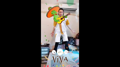 A handsome and sunny boy plays a funny cactus - a guitarist performs a national style Viva costume