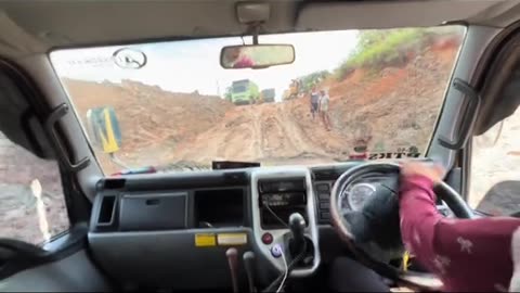 the action of a beautiful female truck driver on a steep road