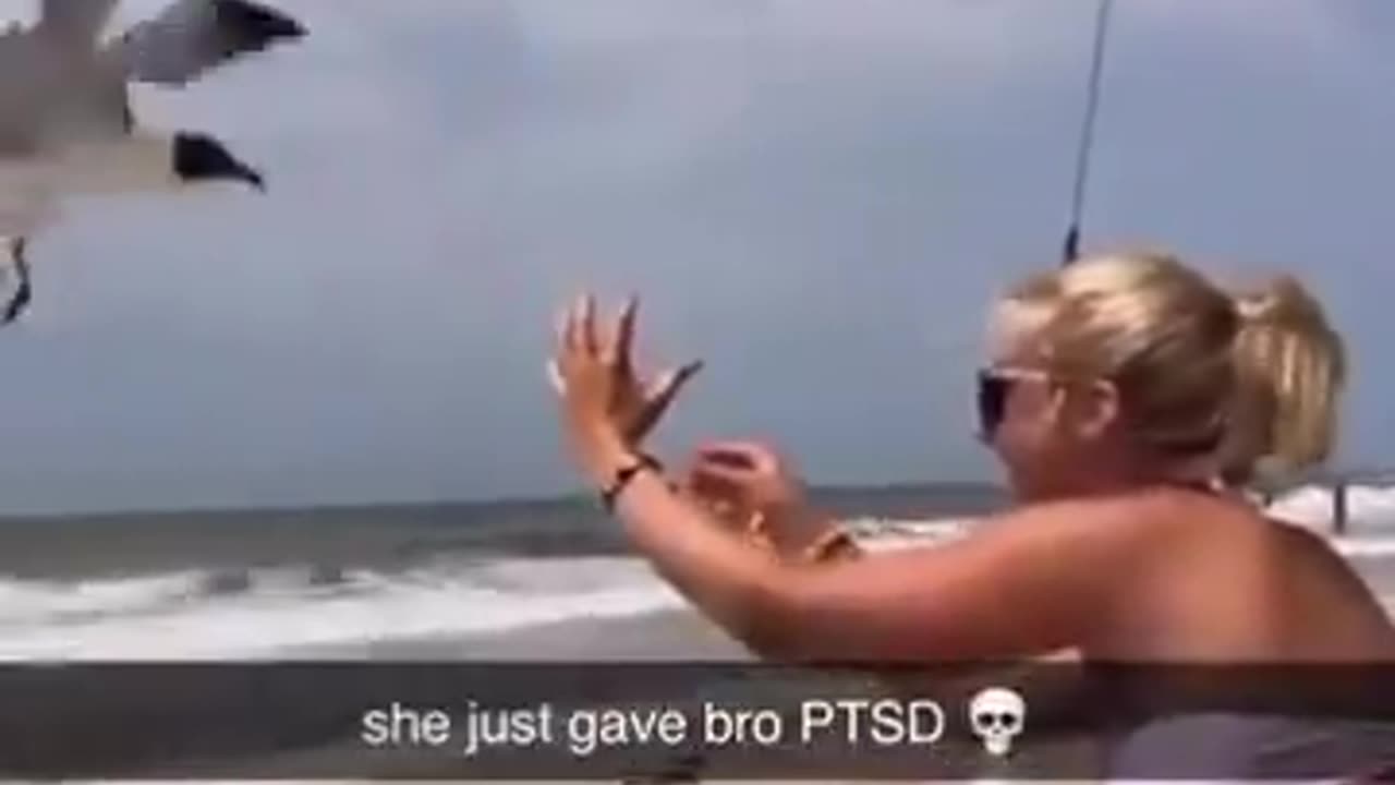 Women on beach snatches seagull out of the sky