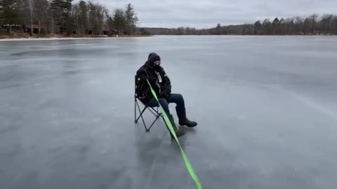 Four Wheeler Pulls Lawn Chair Across Ice