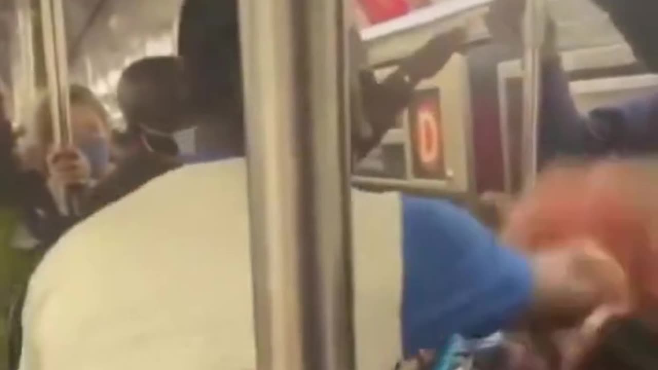 Black man beats white woman on train