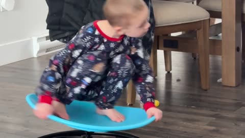 Child Whirls Around On Spin Chair