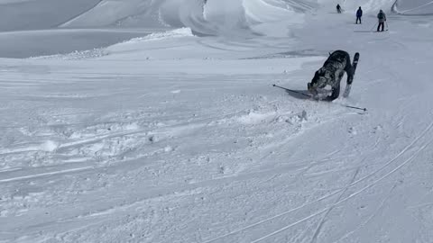 Skier Recovers From Backward Tumble