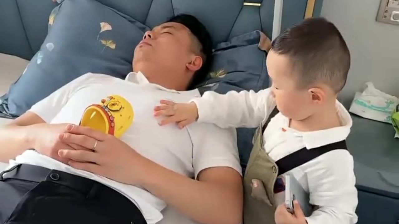 Funny child take the phone from dad