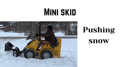 mini skid steer plowing snow