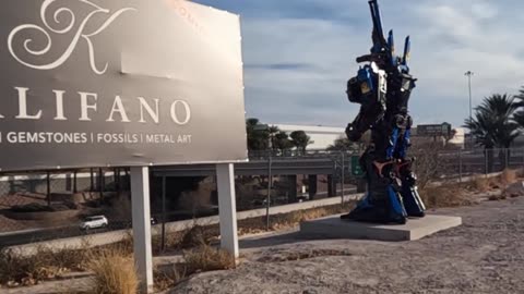 A huge Transformer & Mountain ram welcome visitors to Las Vegas: Overlooking the freeway in silence