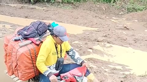 The motorbike almost sank on a road full of mud