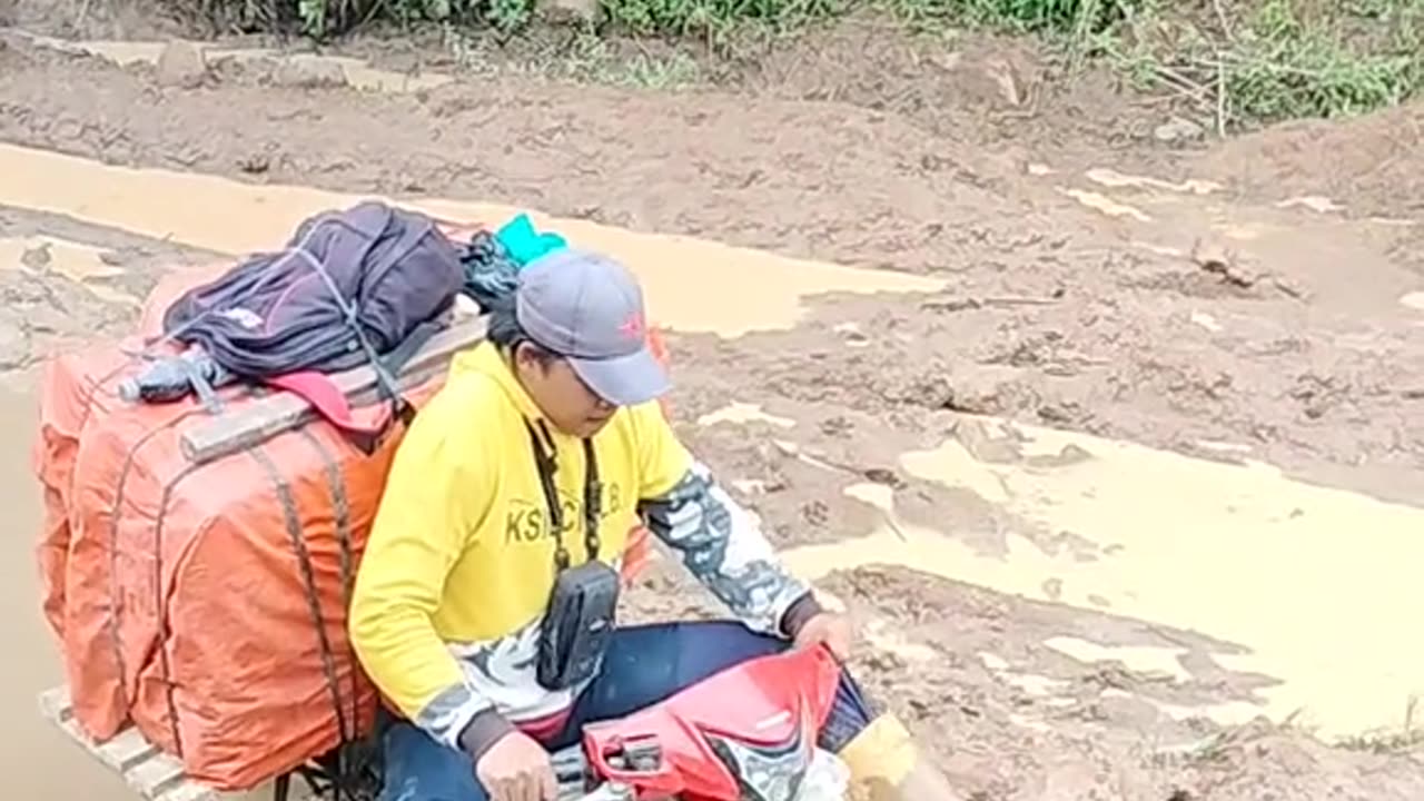 The motorbike almost sank on a road full of mud