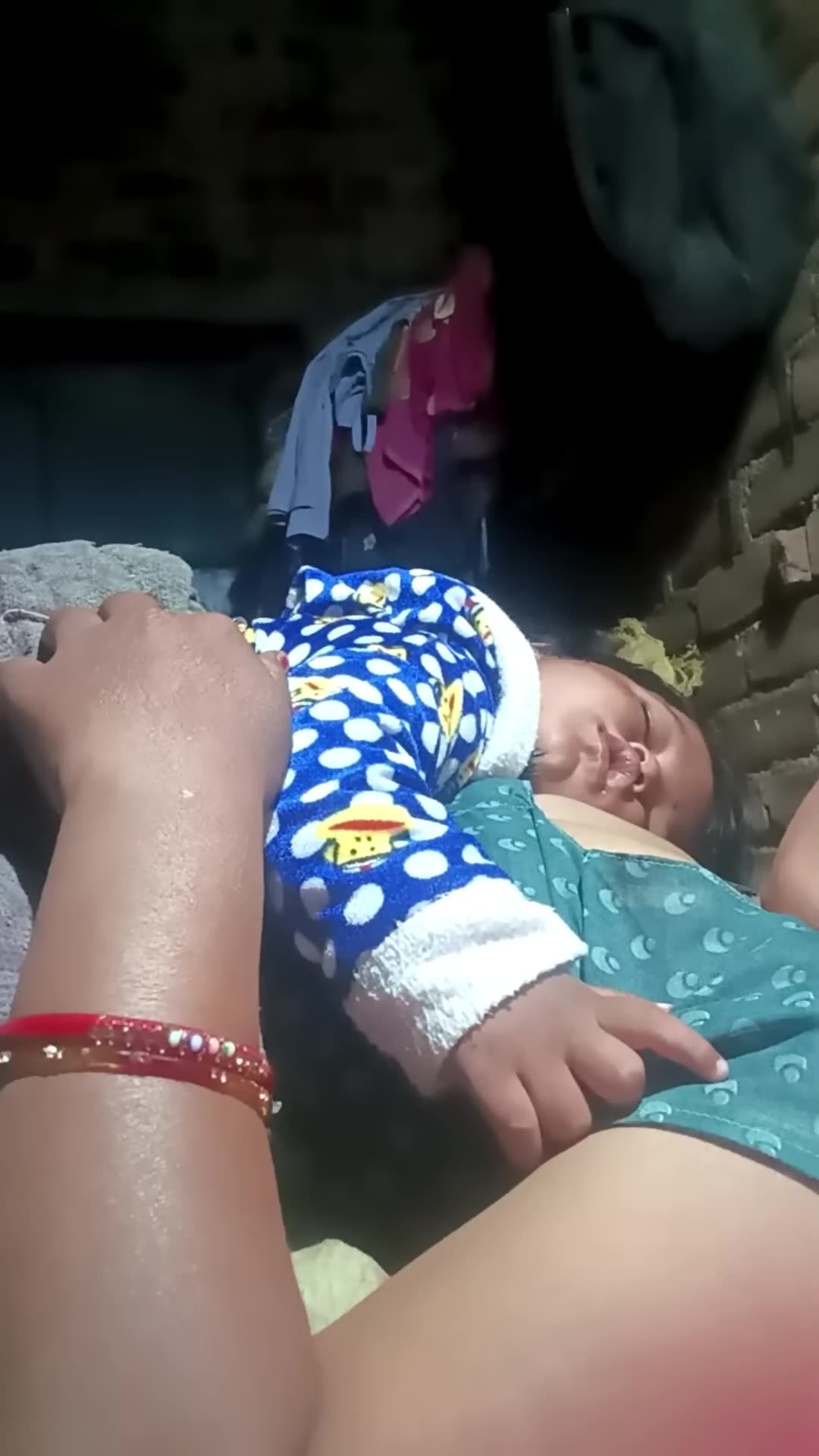 A mother is breastfeeding her baby at night