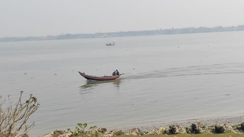 Two fisher man are going to catch fish by boat on the River Hooghly.