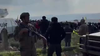 Hezbollah supporters hang their flag on a UN vehicle in southern Lebanon