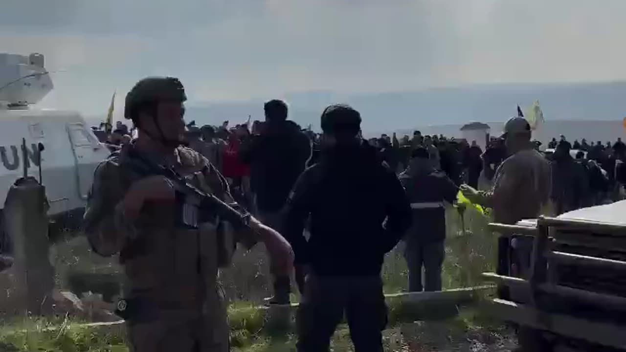 Hezbollah supporters hang their flag on a UN vehicle in southern Lebanon