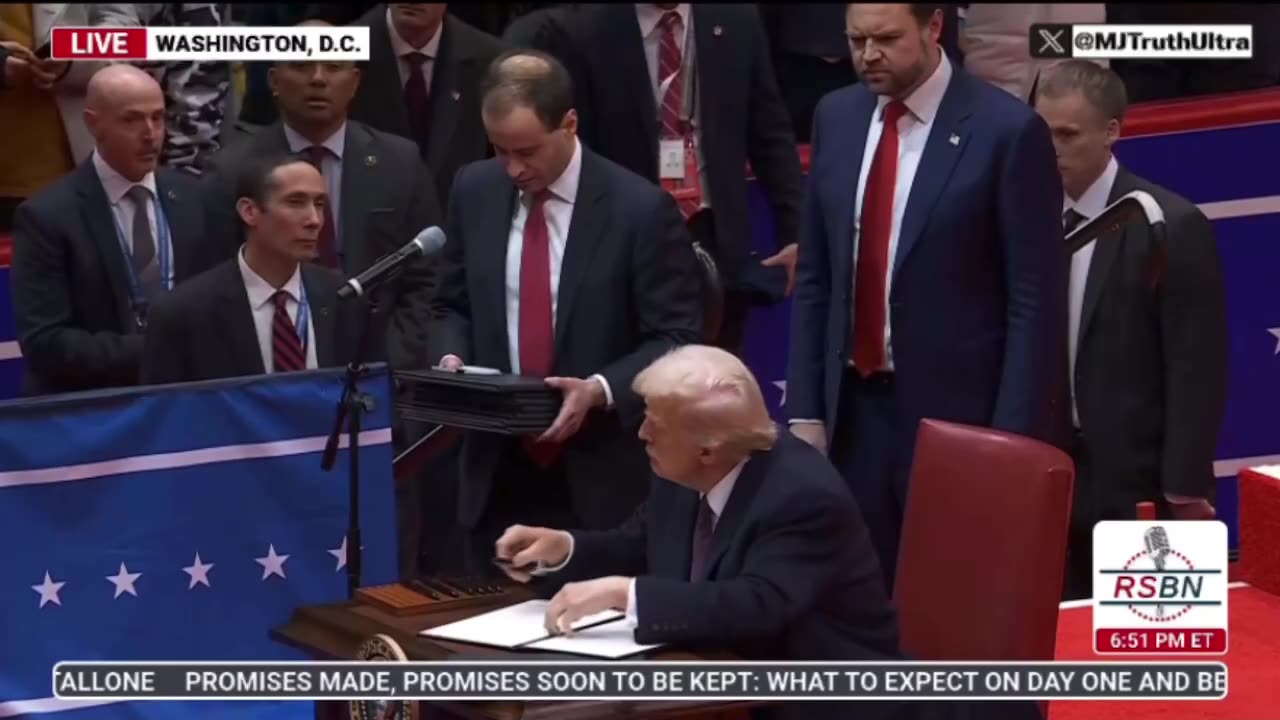 Donald Trump signs and reads aloud the Executive Orders