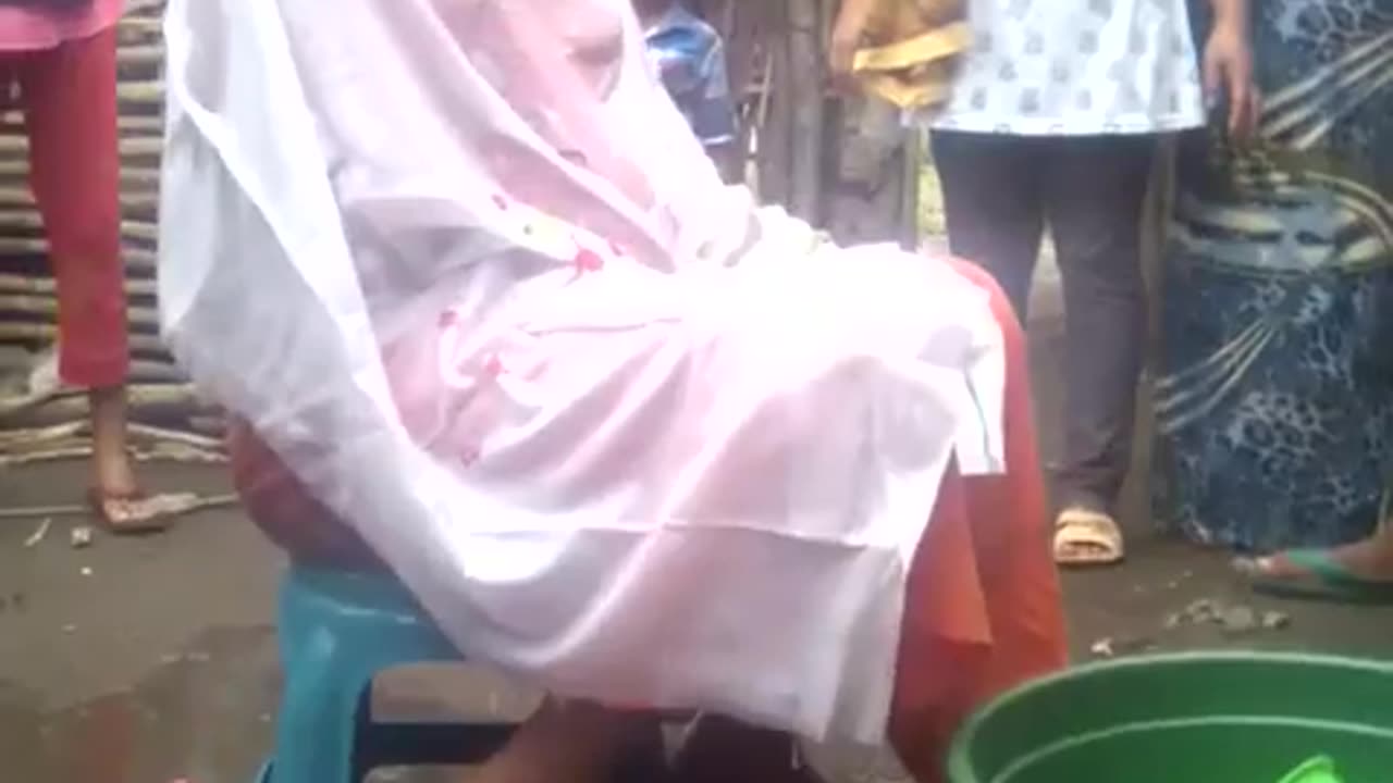 A young girl is being bathed for her wedding