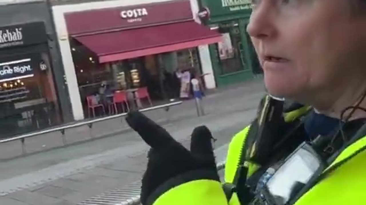 A man takes some photos of the landscape with his smartphone and is stopped