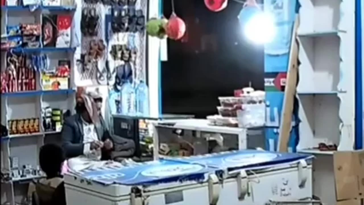 Yemeni shopkeeper is seen sitting in his shop barely reacting to several US air strikes nearby.