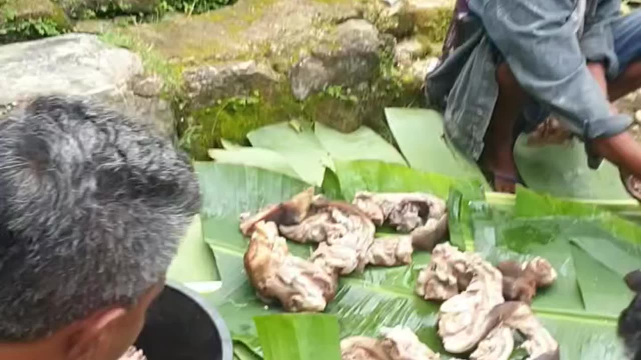 Village people cutting meat