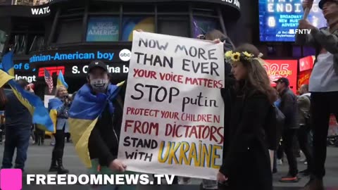 Ukrainians sing Ukraine National Anthem as they gather in emergency protest in Times Square NYC.