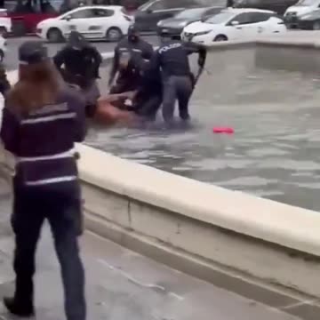 African Migrant naked in fountain - Italy