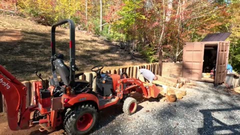 Retaining wall build part2 with old telephone poles.