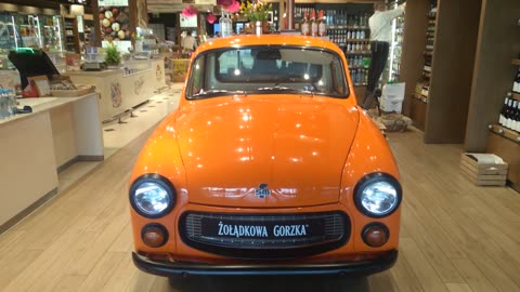 Vodka store with a cool car in it at the Warsaw airport