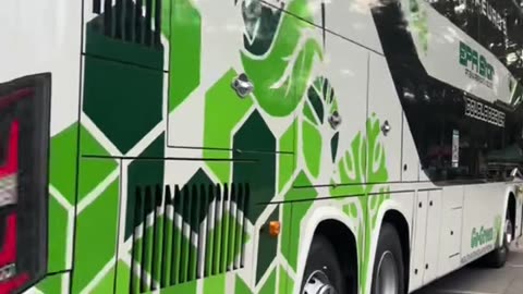 female driver driving a double decker bus