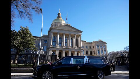 Jimmy Carter's funeral procession drives by Plains, Georgia as crowd gathers to pay respects