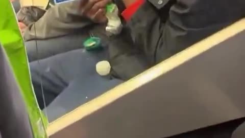 A man openly smokes crack on the tube in London, no one appears to care as