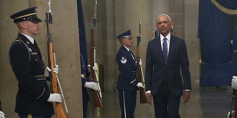 Obama and Clintons draw boos from Trump supporters watching from parade arena