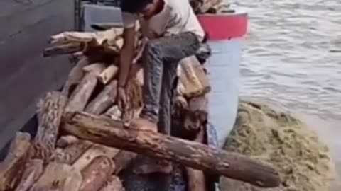 Insane River Risk: Man Spears WHAT in Raging Waters?!