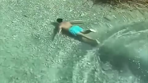 The guy dives into the crystal clear water