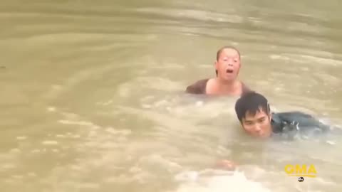 Man saves a woman and her dog from a sinking car.