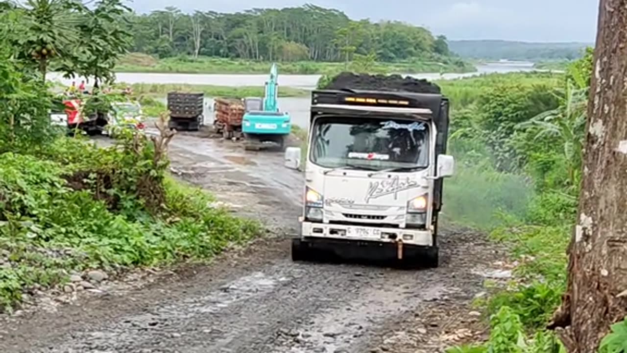 The truck loaded with sand couldn't climb uphill so it ended up being pushed by the truck