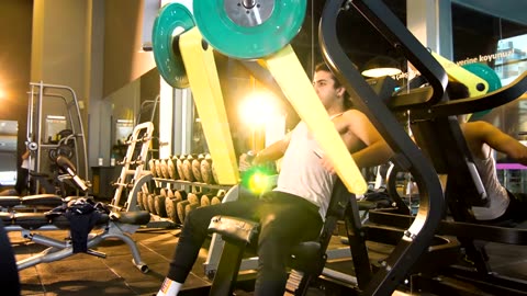 Muscle man lifting weights in a gym