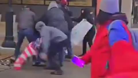 Foreign mob surrounds Trump supporter and tears down his American flag during protest