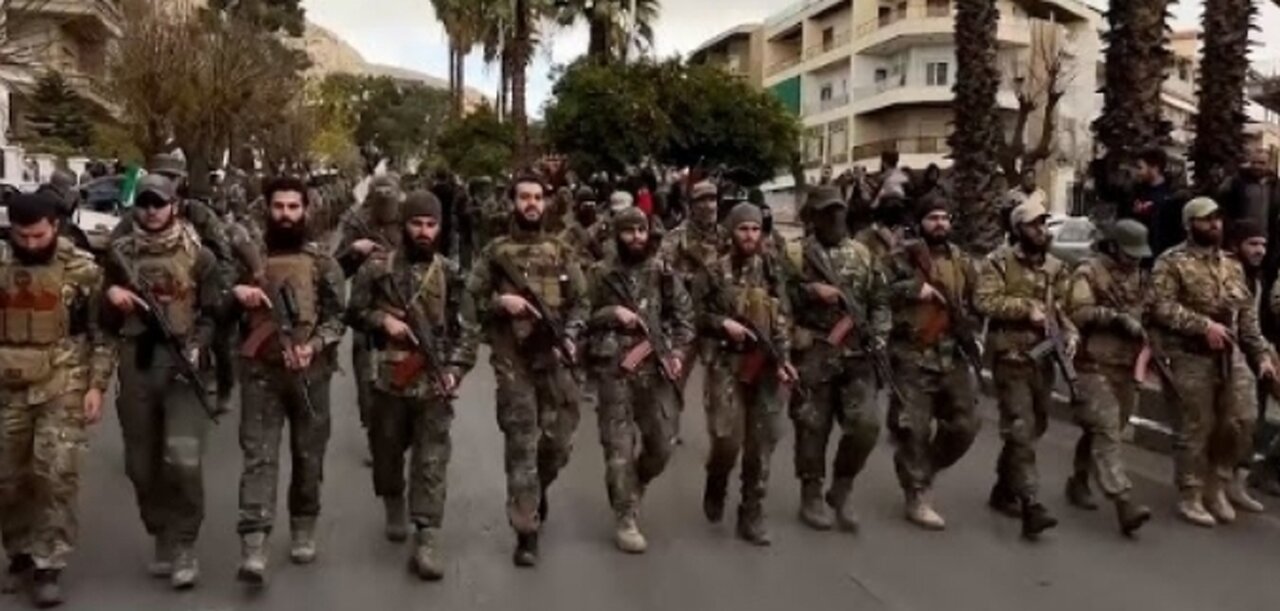 Hundreds of Syrian armed rebels parade in Damascus streets as a show of force