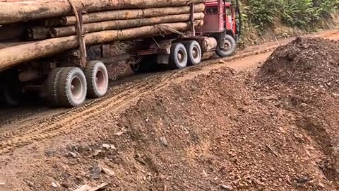 truck loaded with wood climbs up the mountain