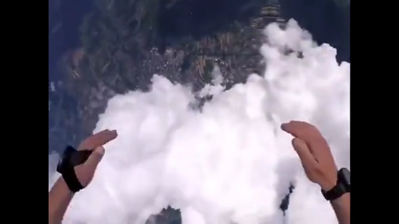 Skydiver falls through a through a raincloud