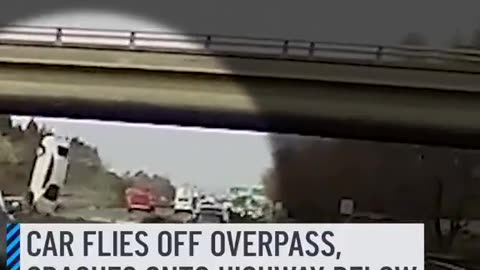 car flies off an overpass and lands on a busy highway