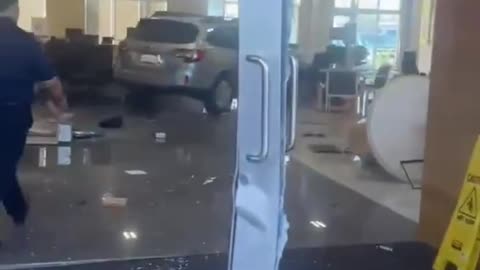At least eight people were injured Saturday after a driver rammed a car into a CarMax