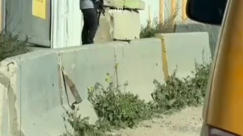 An armed settler at a military checkpoint of the occupation army west of Nablus