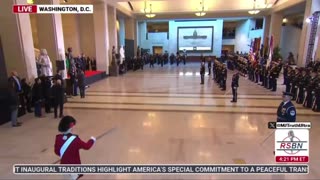 Trump is escorted around the room at the Military Ceremony