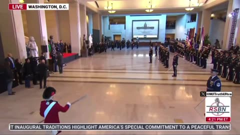 Trump is escorted around the room at the Military Ceremony