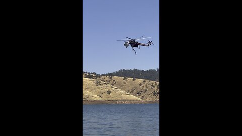Helicopter getting water for fire