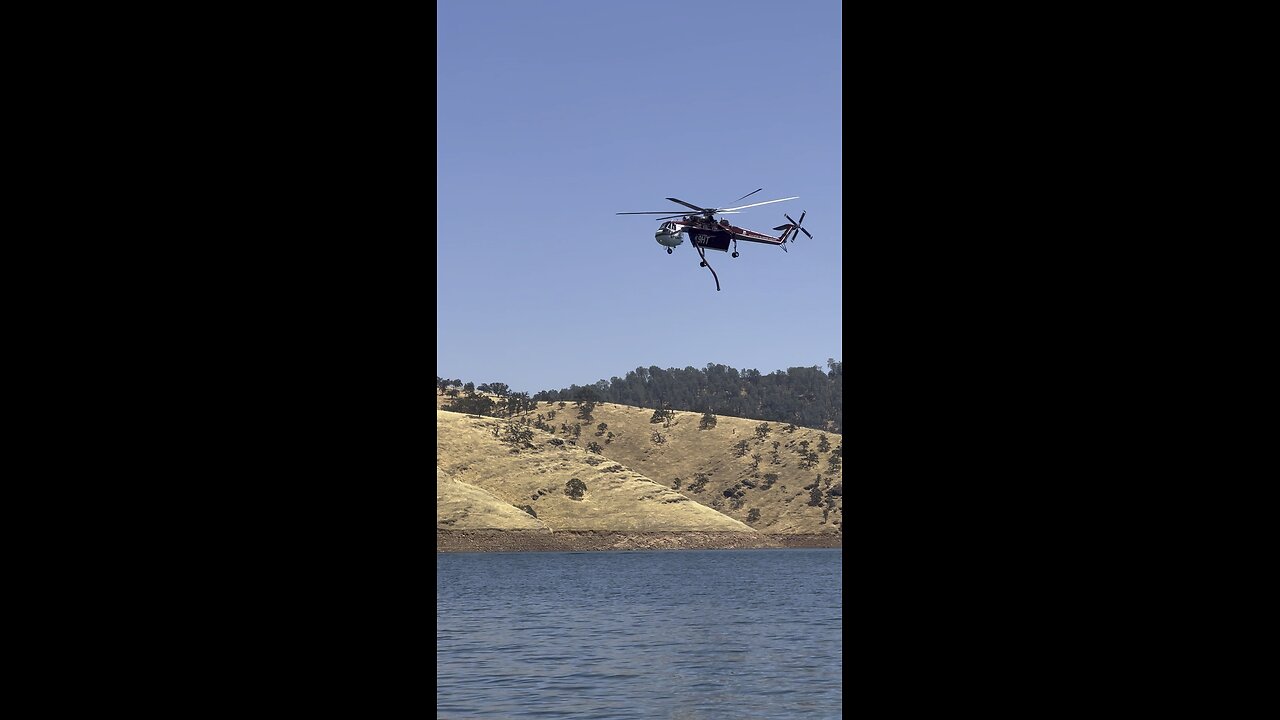 Helicopter getting water for fire