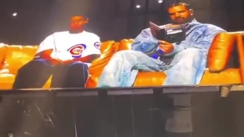 Drake hologram reads book to himself on stage