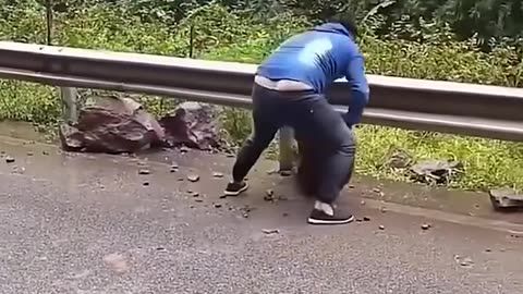 Man gets rocks out of the road