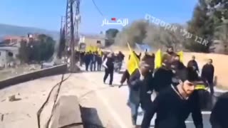 The Lebanese enter the village of Hula in southern Lebanon with Hezbollah flags