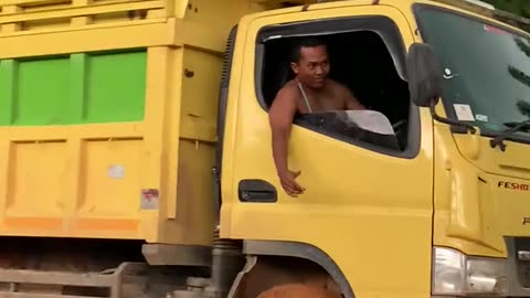 truck loaded with palm oil tilted on extreme road