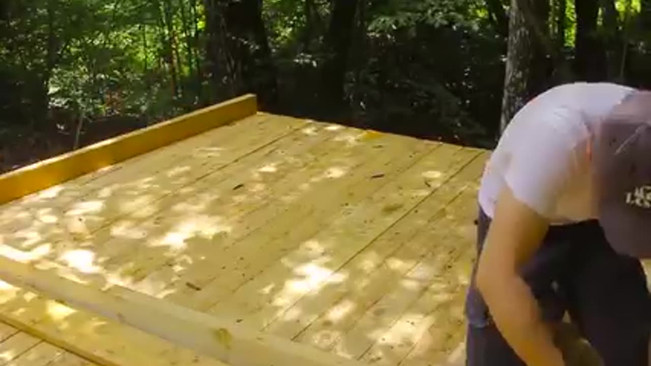 Man build a wooden room alone in forest.